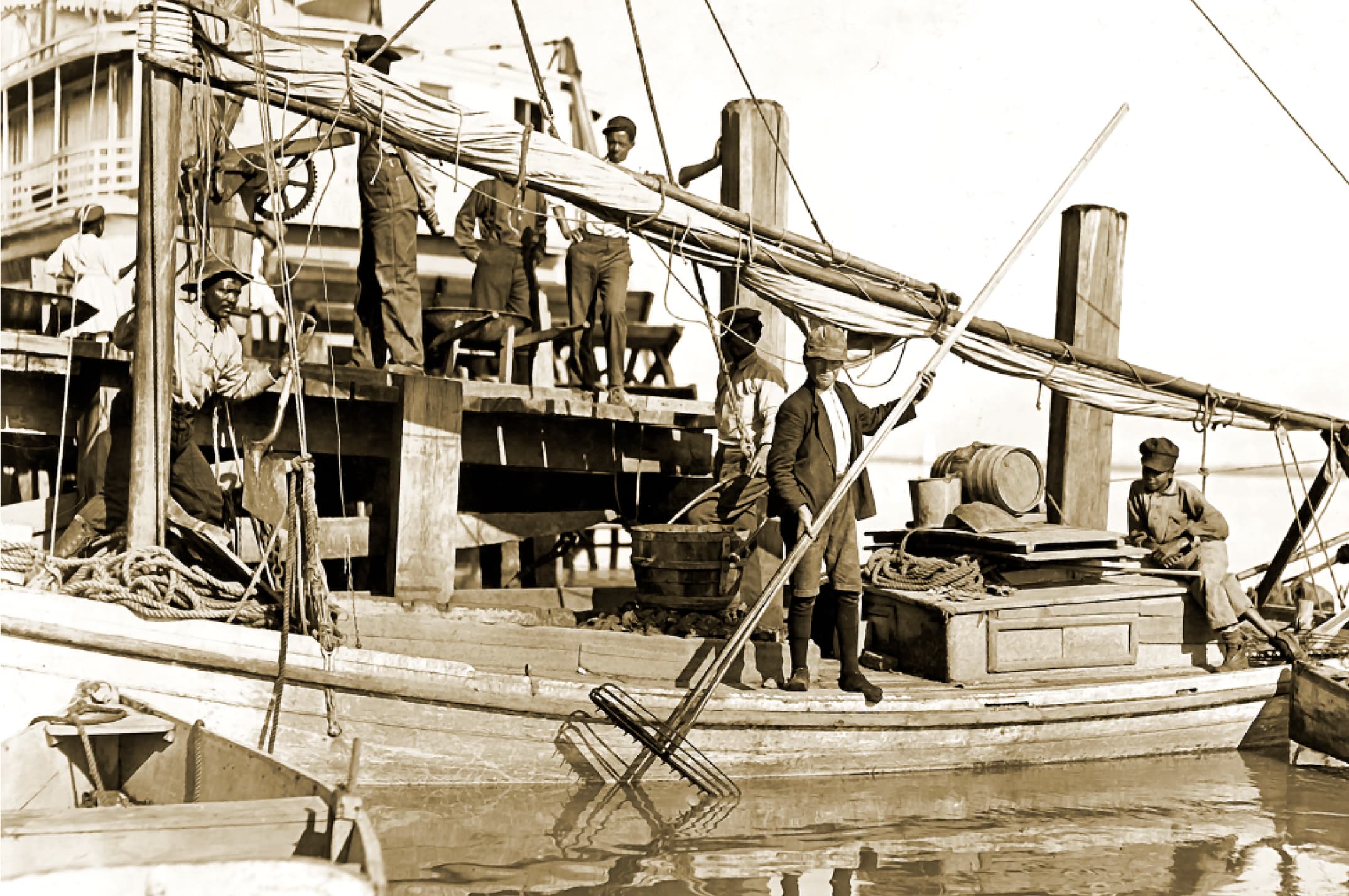 Sepia photograph of a commercial oyster vessel at the dock