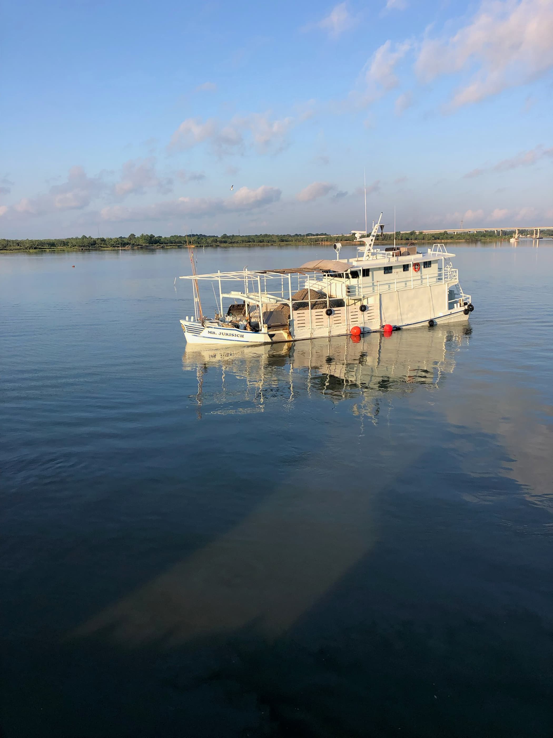 Commercial oyster boats working a lease at dawn